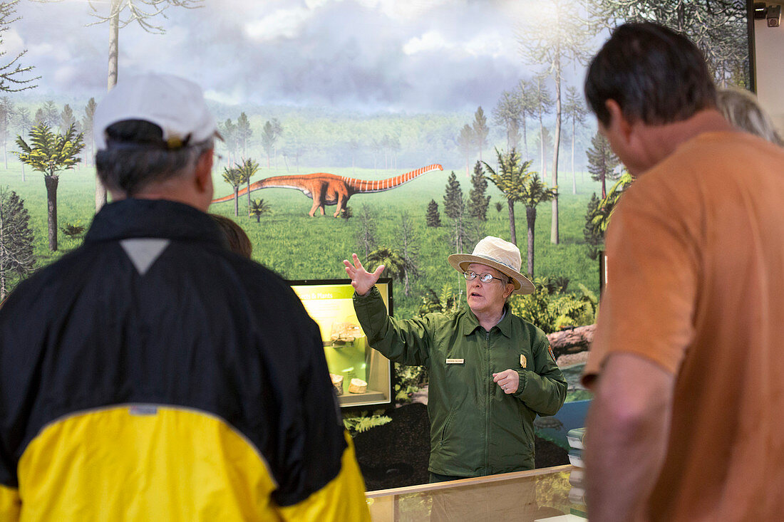 Park ranger at a dinosaur exhibit