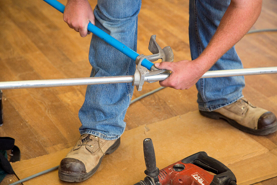 Electrician using a pipe bender