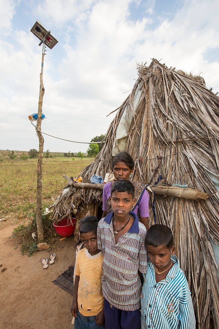 An untouchable family outside their hut