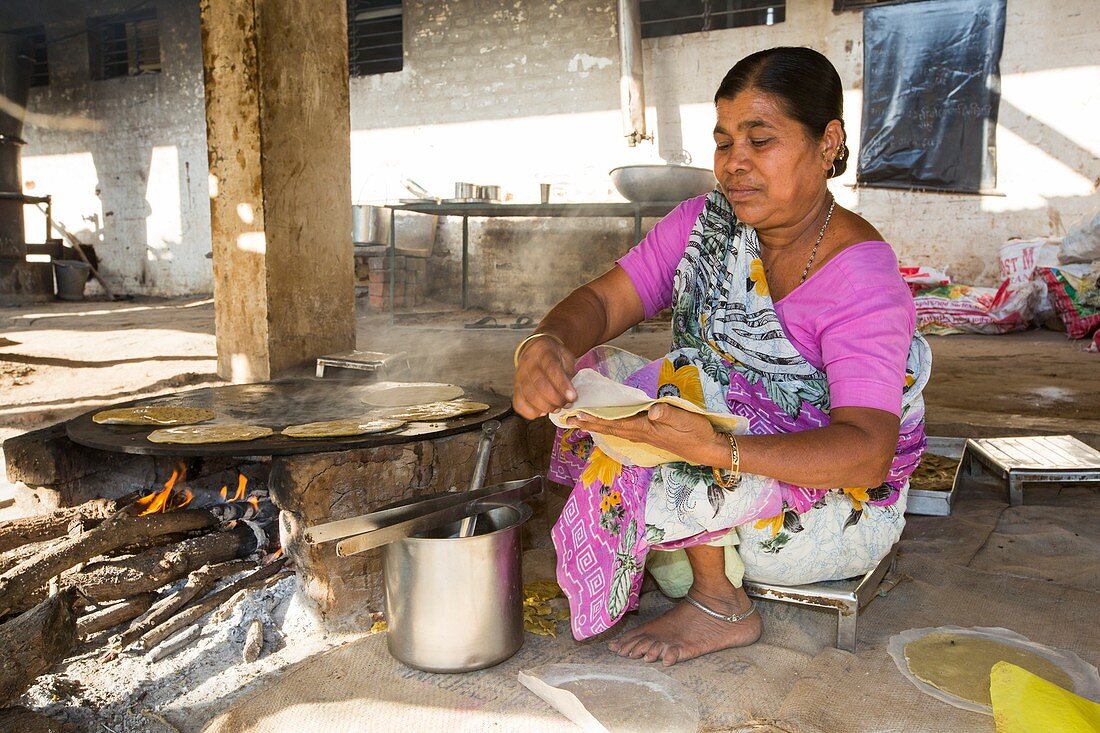 Woman preparing chapatis,India