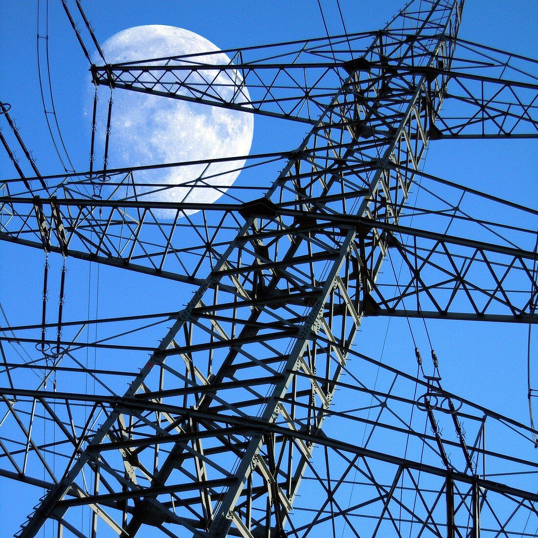 Moon behind electricity pylons