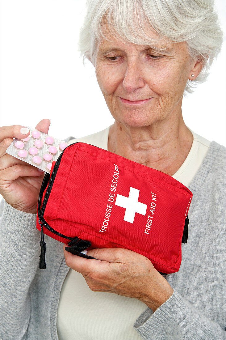 Elderly woman with first aid kit