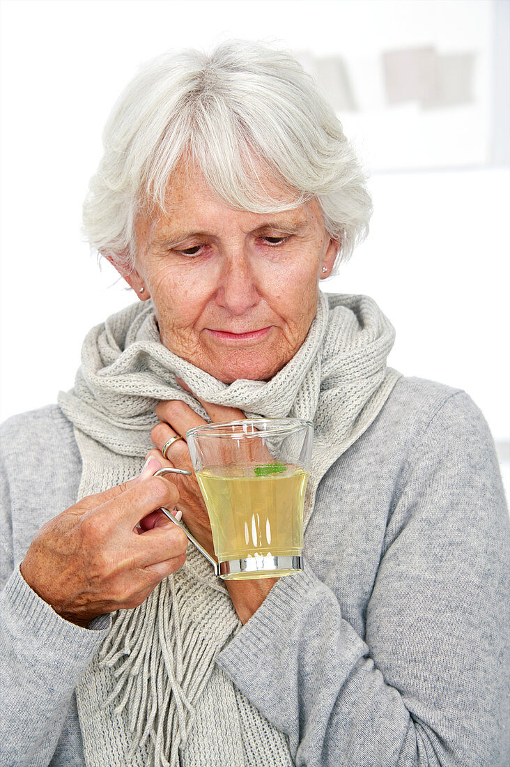 Elderly woman drinking hot lemon