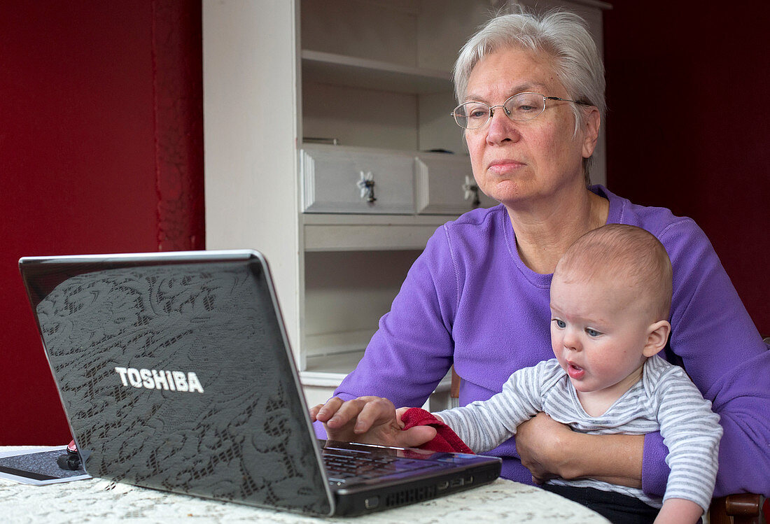 Grandmother and baby using a computer