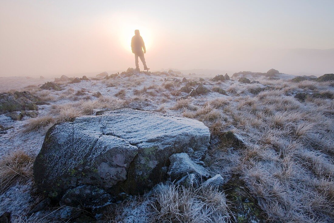 A walker on the summit of Caudale Moor