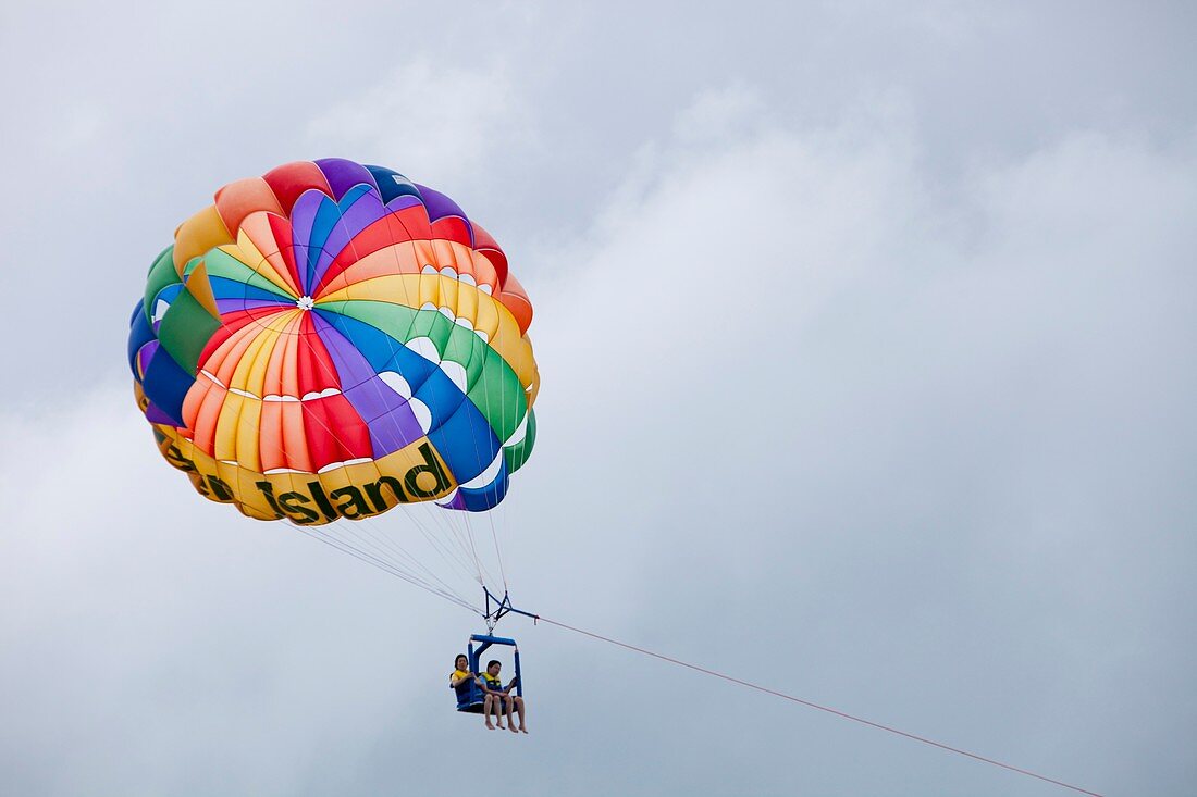 Tourists parasailing off Green Island
