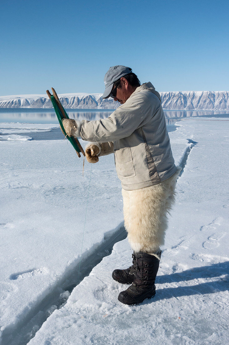 Inuit hunter line fishing