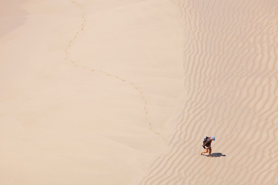 Man leaving footprints on beach