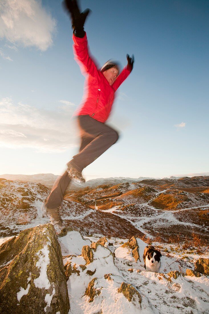 Man leaping off rock