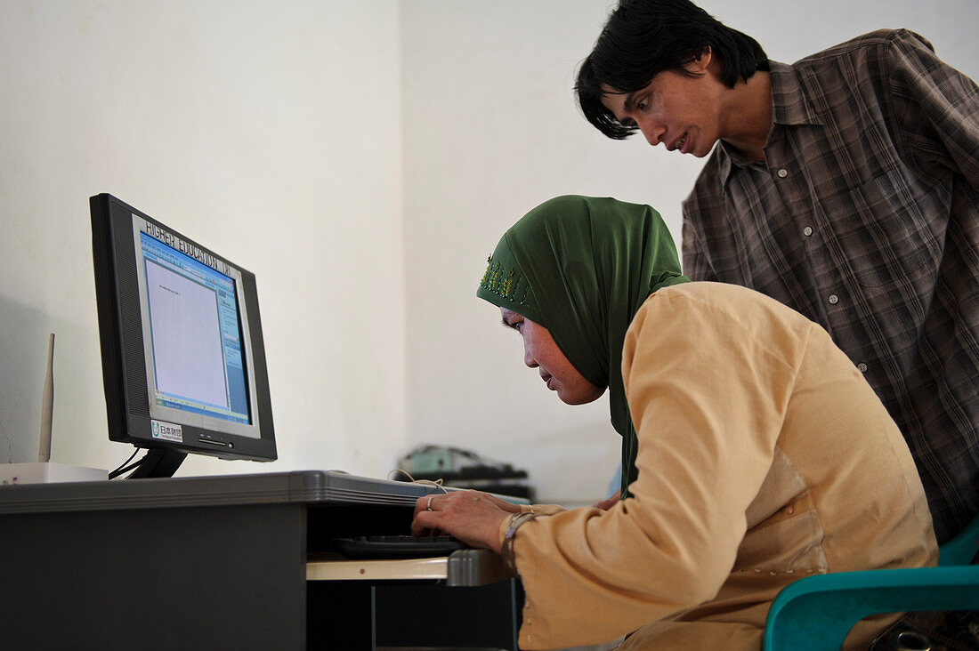 Visually impaired woman using computer