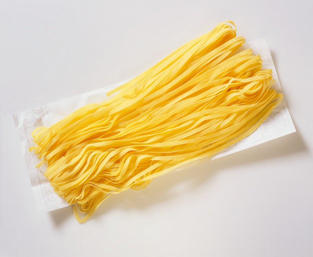 Freshly made fettuccine on paper