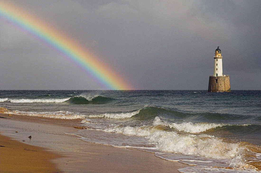 Rainbow beside a lighthouse