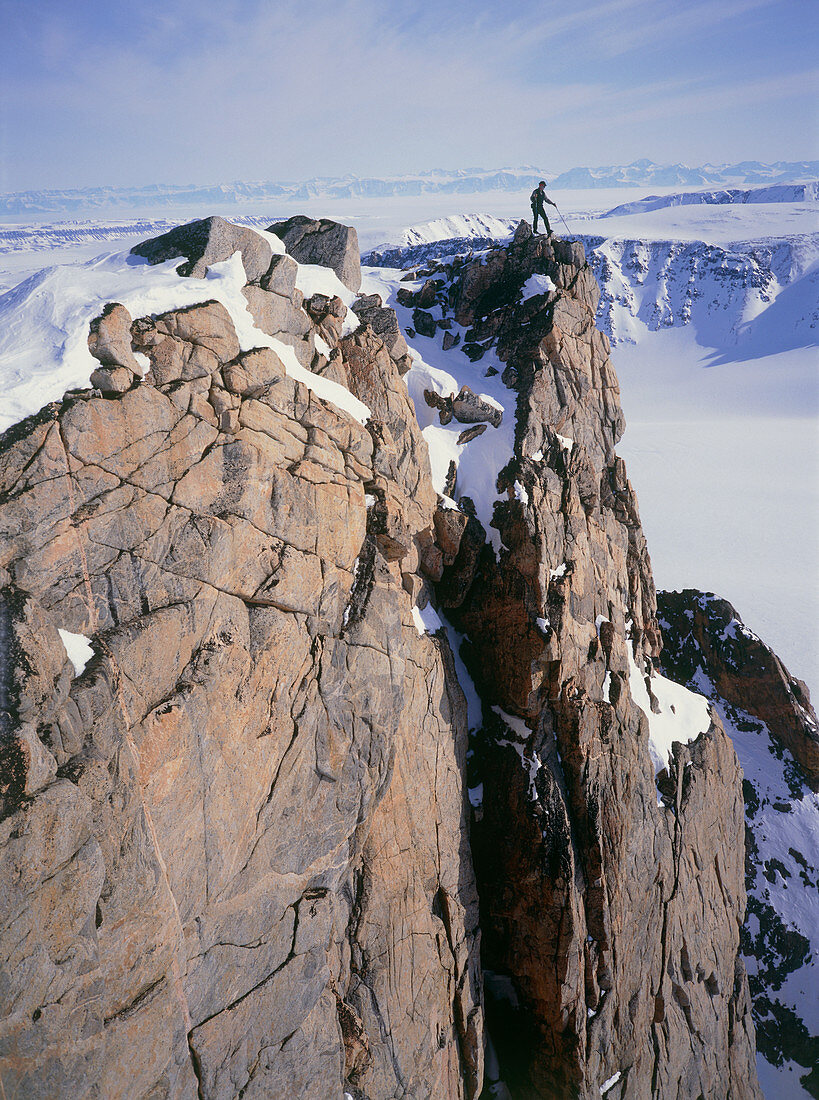 Mountaineer on the summit of a Greenland peak