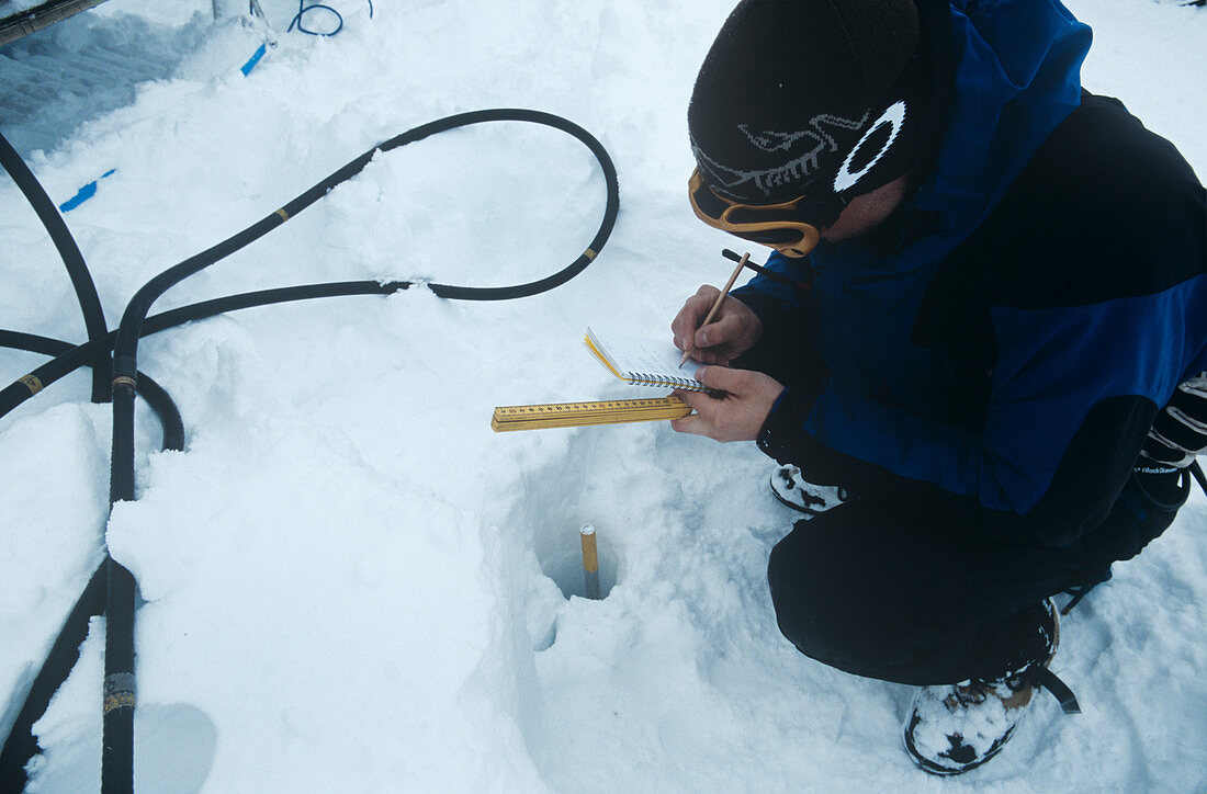 Glaciologist measuring a glacier