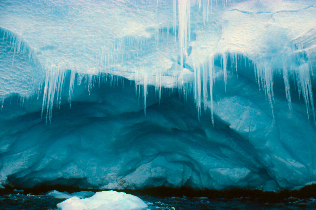 Icicles and cave on a coastal ice cliff,Antarctic