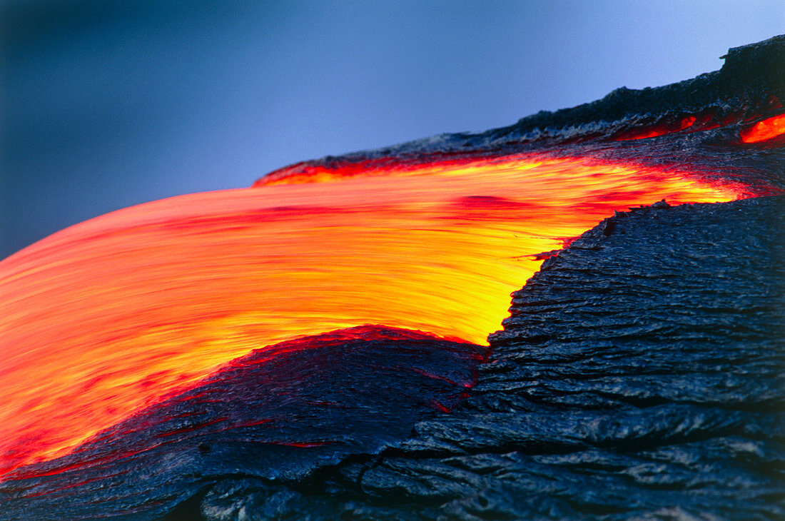 Molten pahoehoe lava spilling from a lava tube