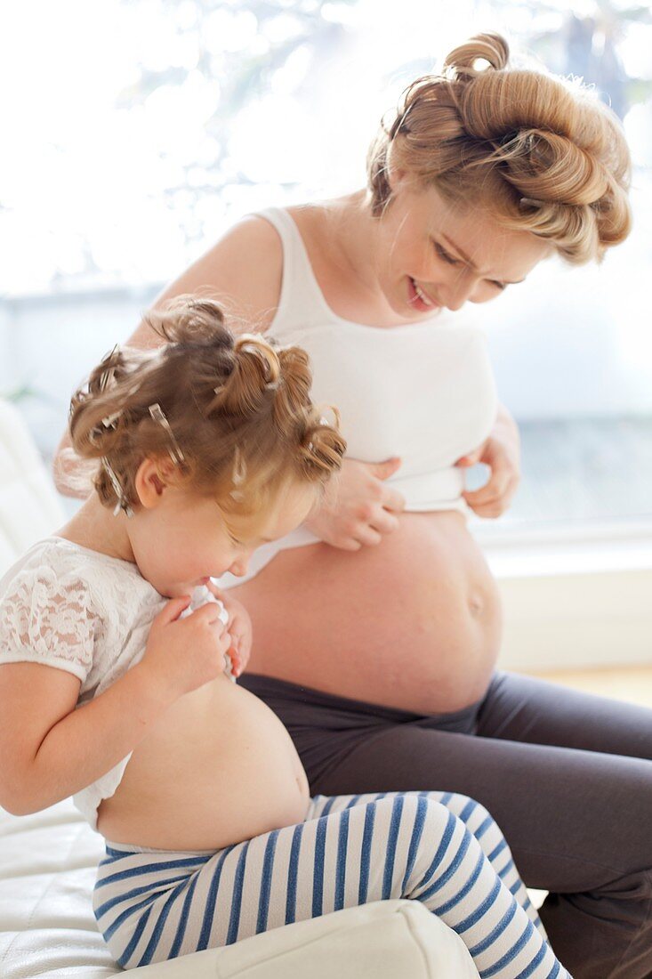 Pregnant woman and daughter