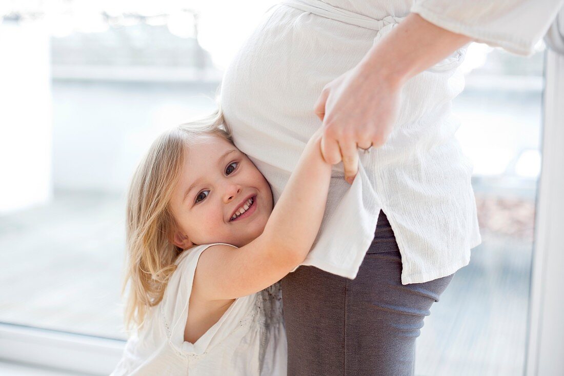 Girl with pregnant mother