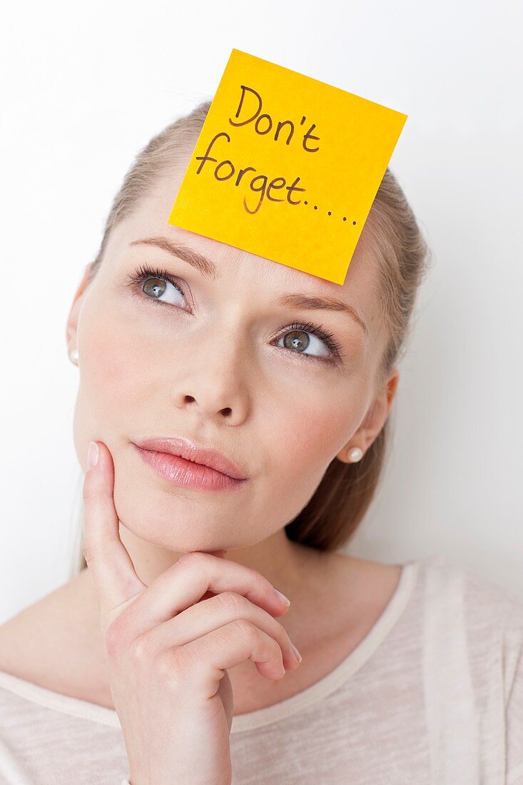 Young woman with sticky note