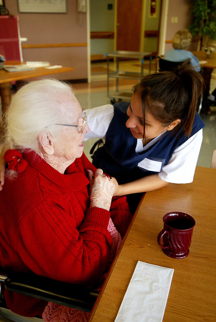 Nurse Interacting With an Elderly Woman