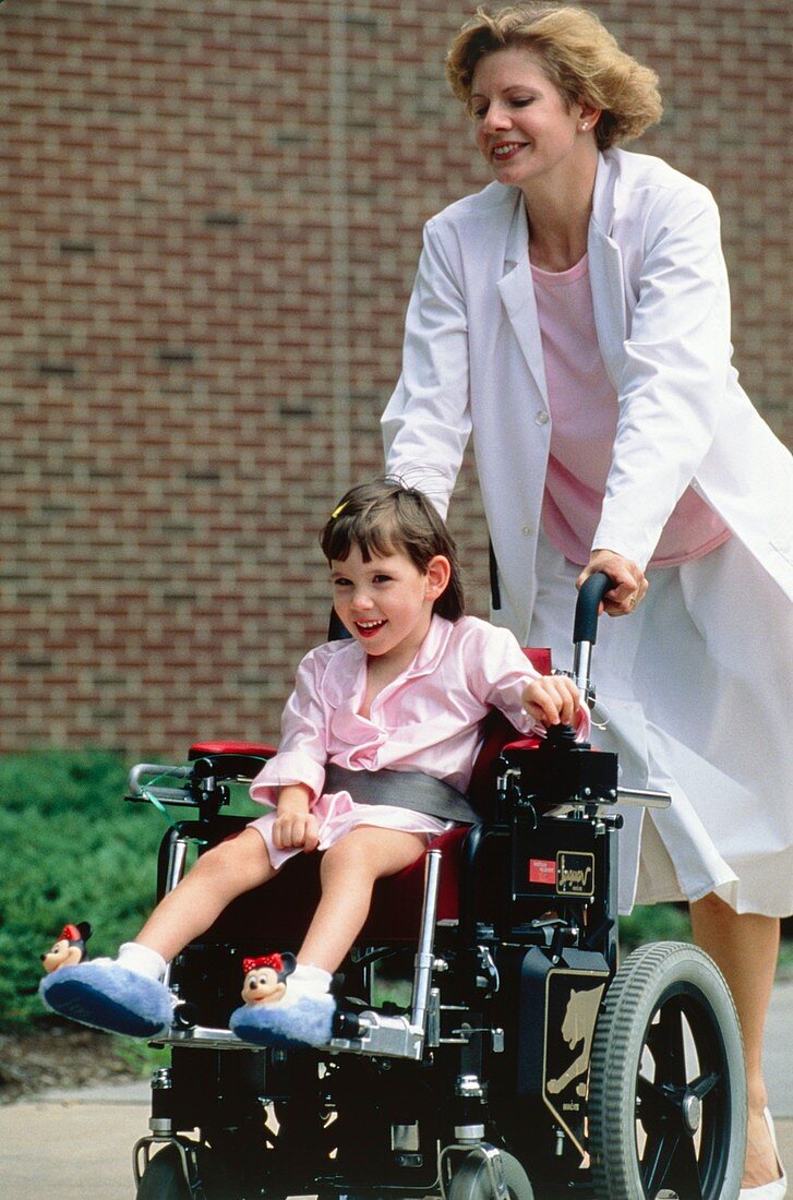 Child with cerebral palsy being wheeled about