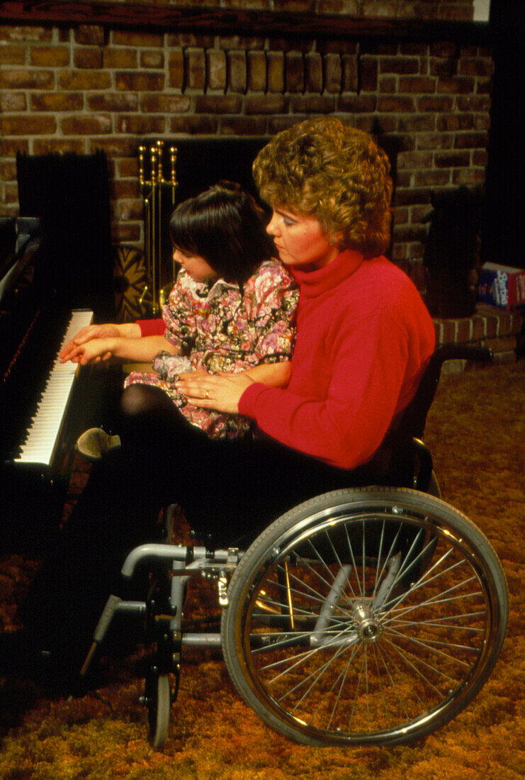 Handicapped mother teaching her daughter piano