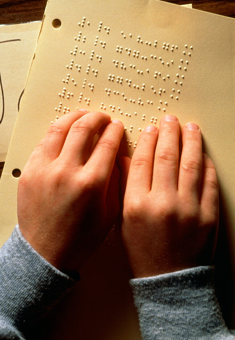 Blind boy reading braille