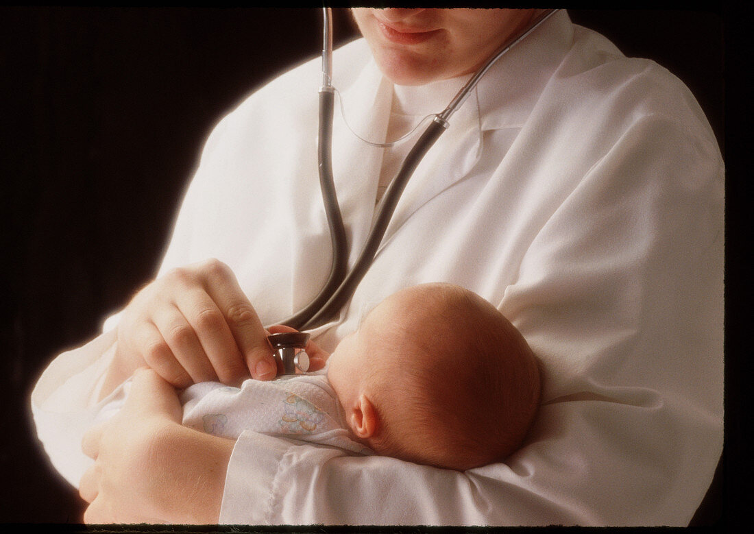 Doctor examines newborn baby with a stethoscope