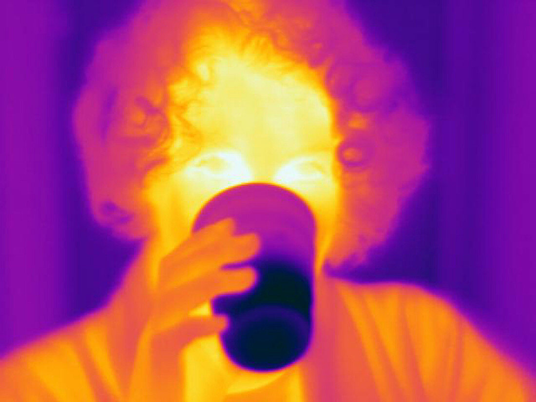 A thermogram of a woman with a cool drink