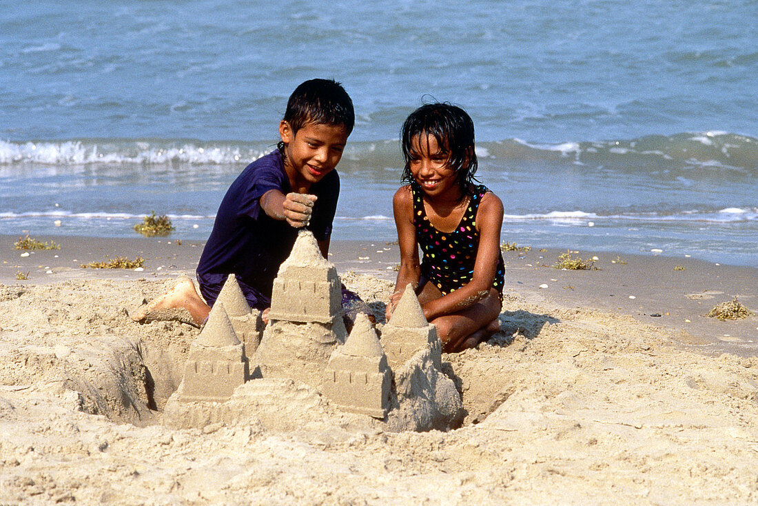 Children build sand castle,Texas Gulf Coast