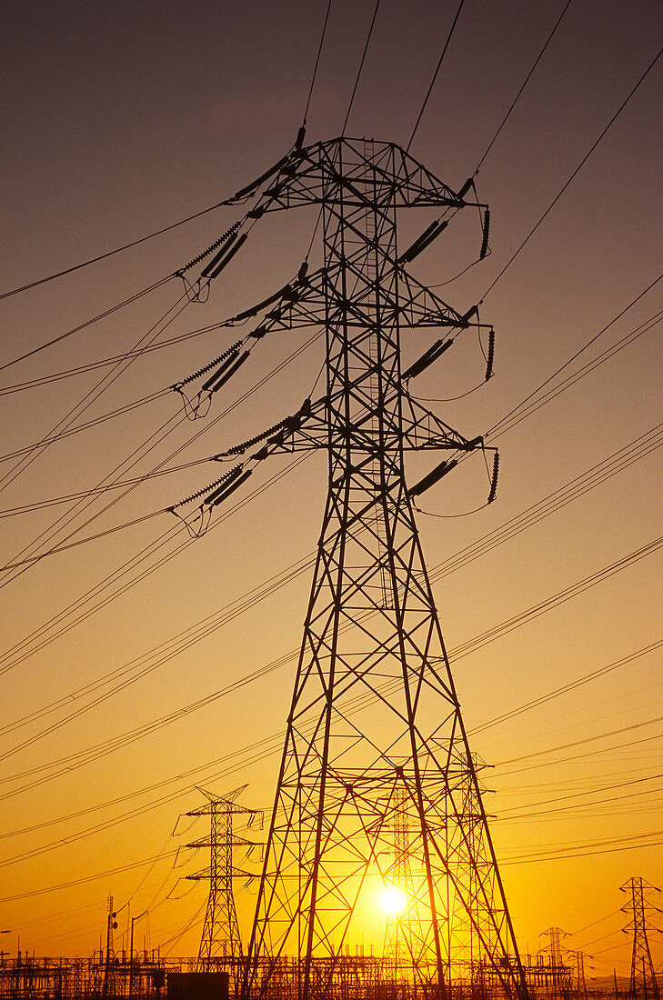 Sunset behind power lines & pylon,USA