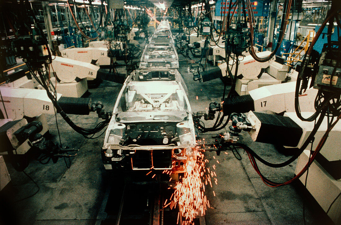 Robots welding on car assembly line