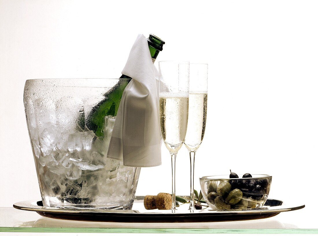 Champagne in an Ice Bucket with Two Glasses and Olives
