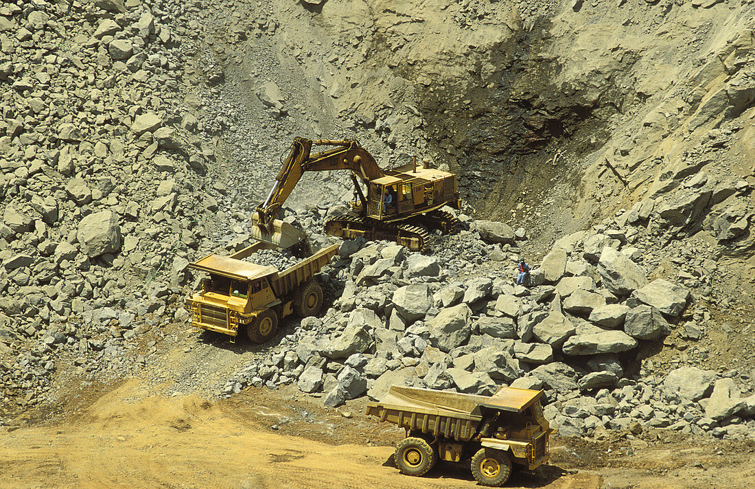 Tracked loader and dump truck in gold mine