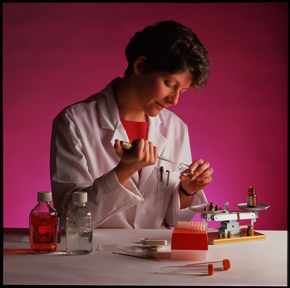Female chemist uses pipette