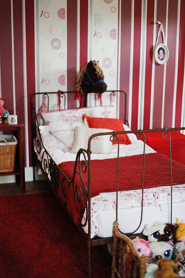 Hobby horse in vintage child's bedroom with red and white colour scheme