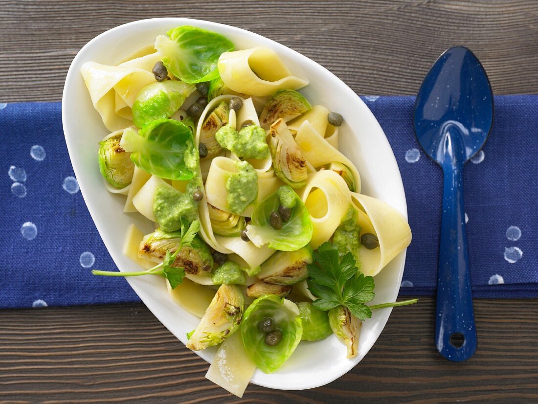 Flat ribbon pasta with Brussels sprouts, capers and parsley pesto