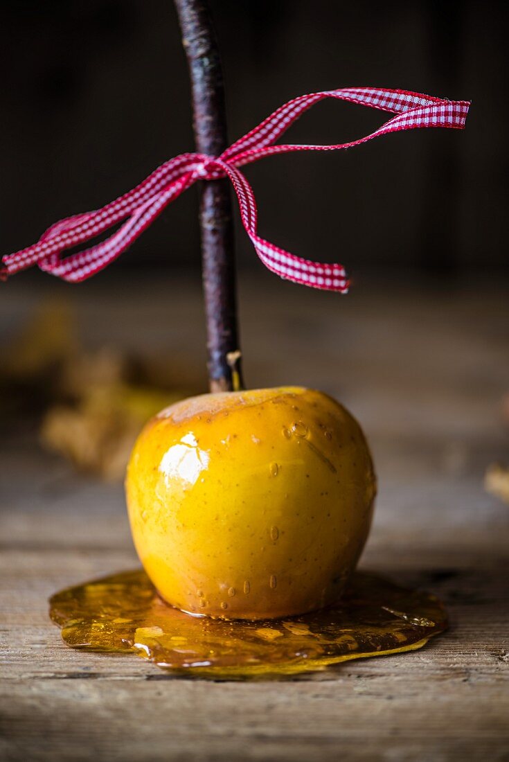 A toffee apple on a wooden surface