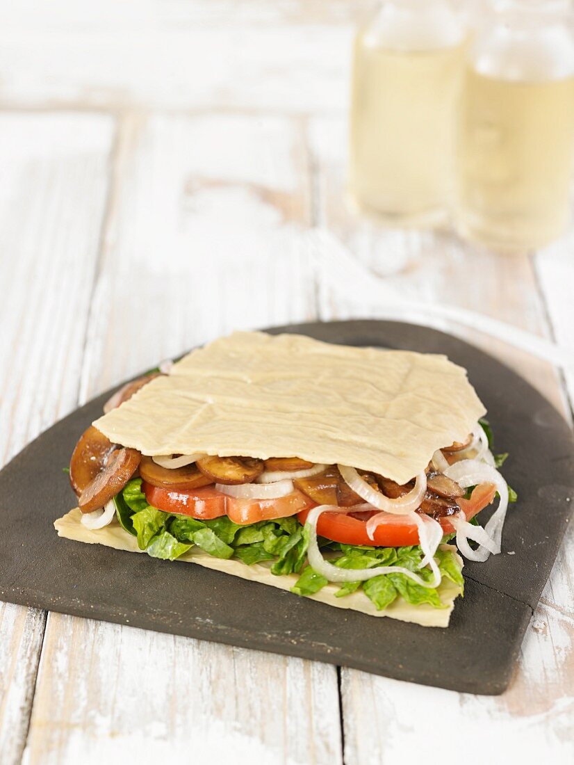 A Parmesan taco filled with lettuce, tomatoes and shiitake mushrooms