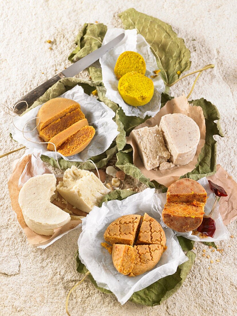 Different types of vegan cheese seasoned with argan oil, curry powder and turmeric