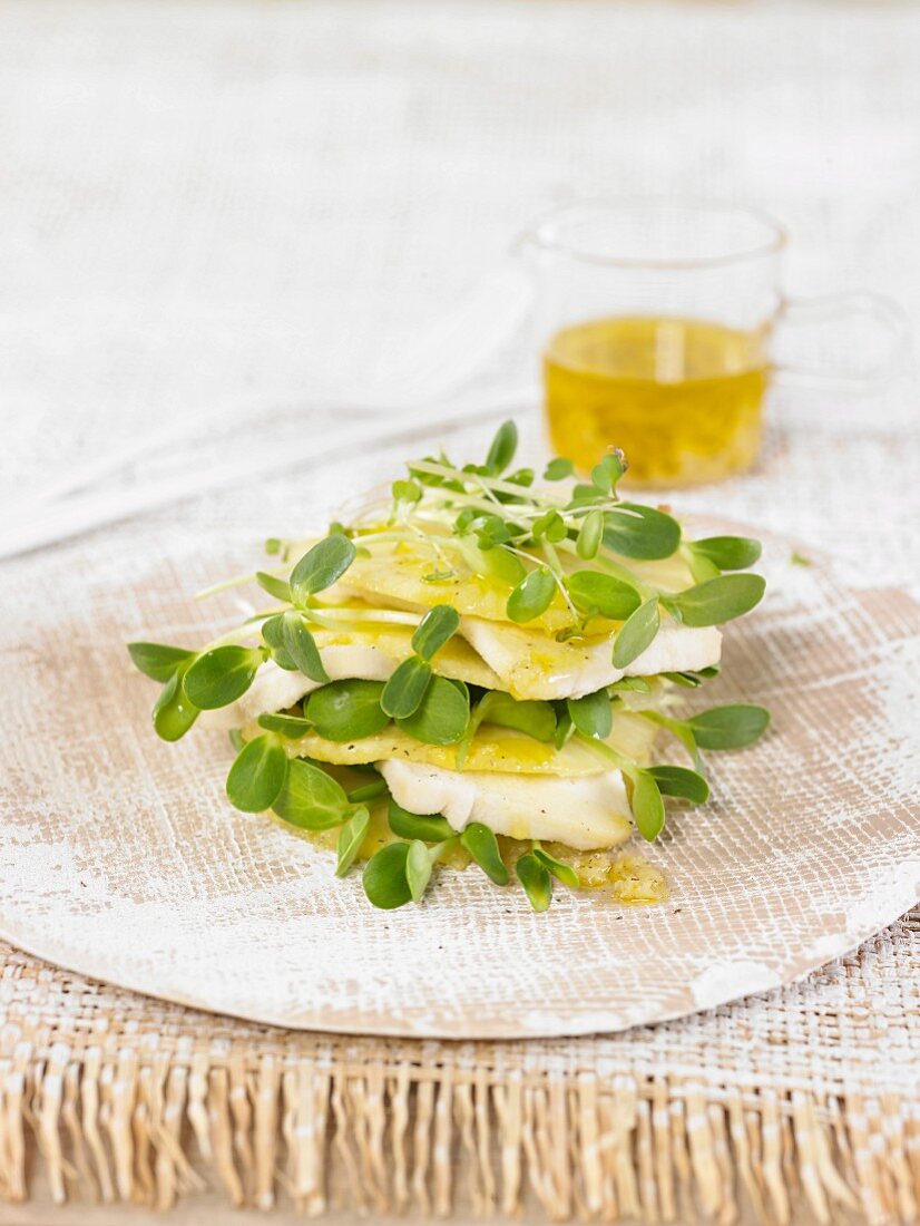 A pineapple and macadamia nut tower with sunflower shoots and ginger vinaigrette