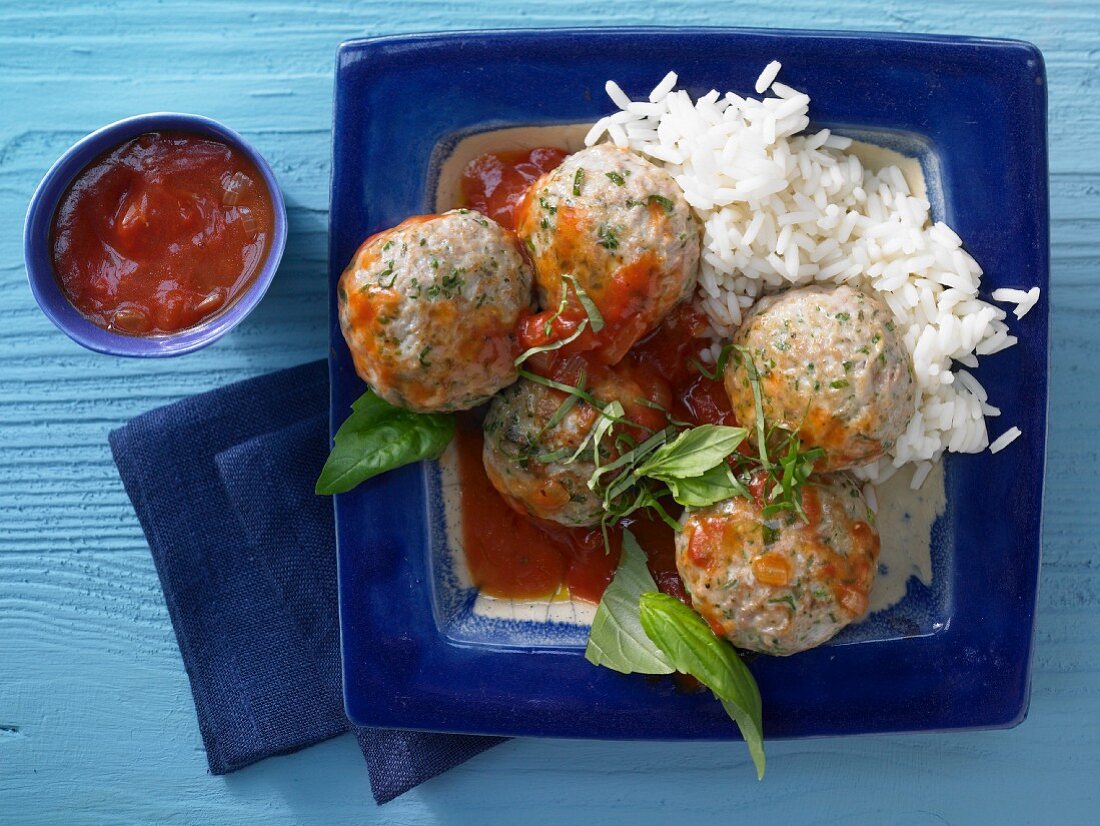Basil and veal dumplings with tomato sauce and rice