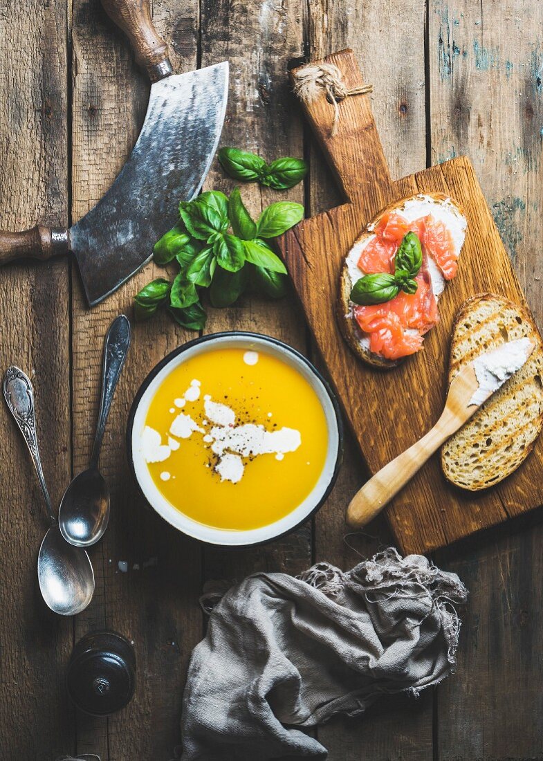 Pumpkin cream soup and salmon, ricotta and basil toasts
