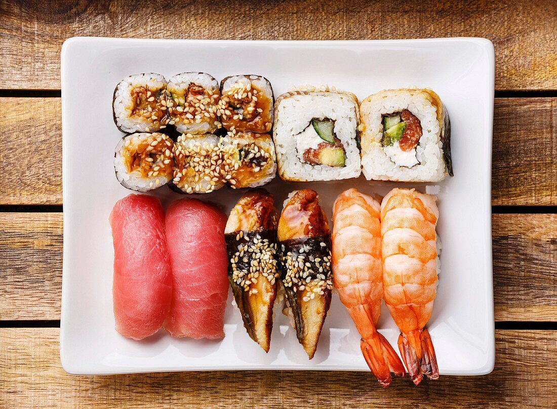 Sushi Set nigiri and rolls on wooden background
