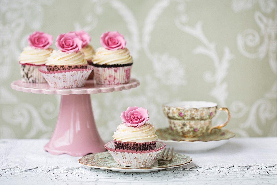 Afternoon tea with rose cupcakes served on vintage china