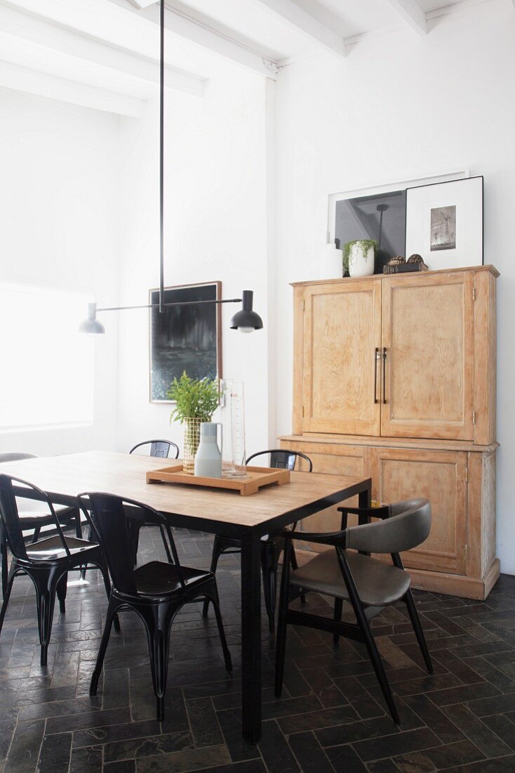 Classic chairs around dining table in renovated period apartment