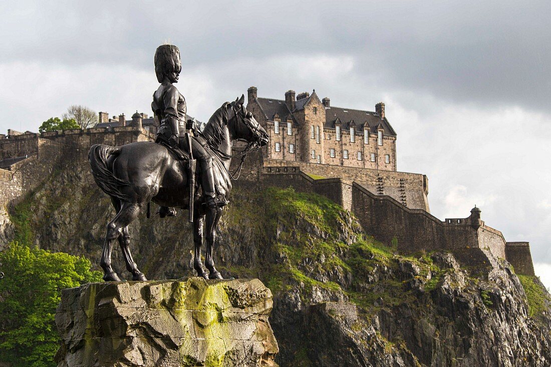 The Royal Scots Greys monument with Edinburgh Castle in Edinburgh Scotland