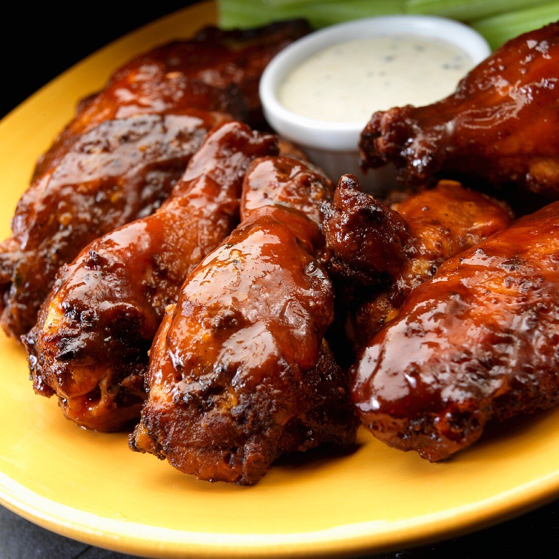 Smoked chicken wings with ranch dressing and celery