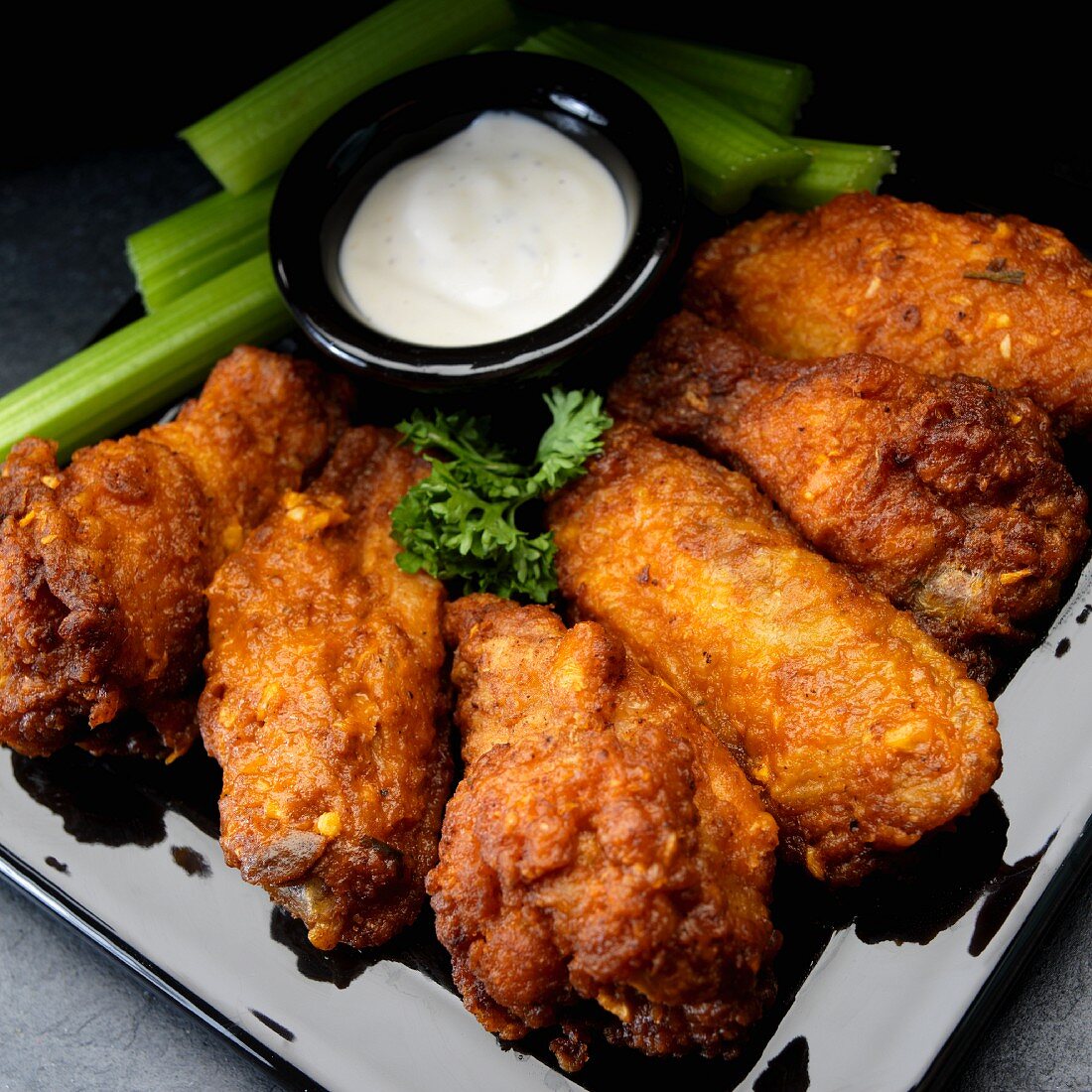 Buffalo chicken wings with garlic, celery and ranch dressing