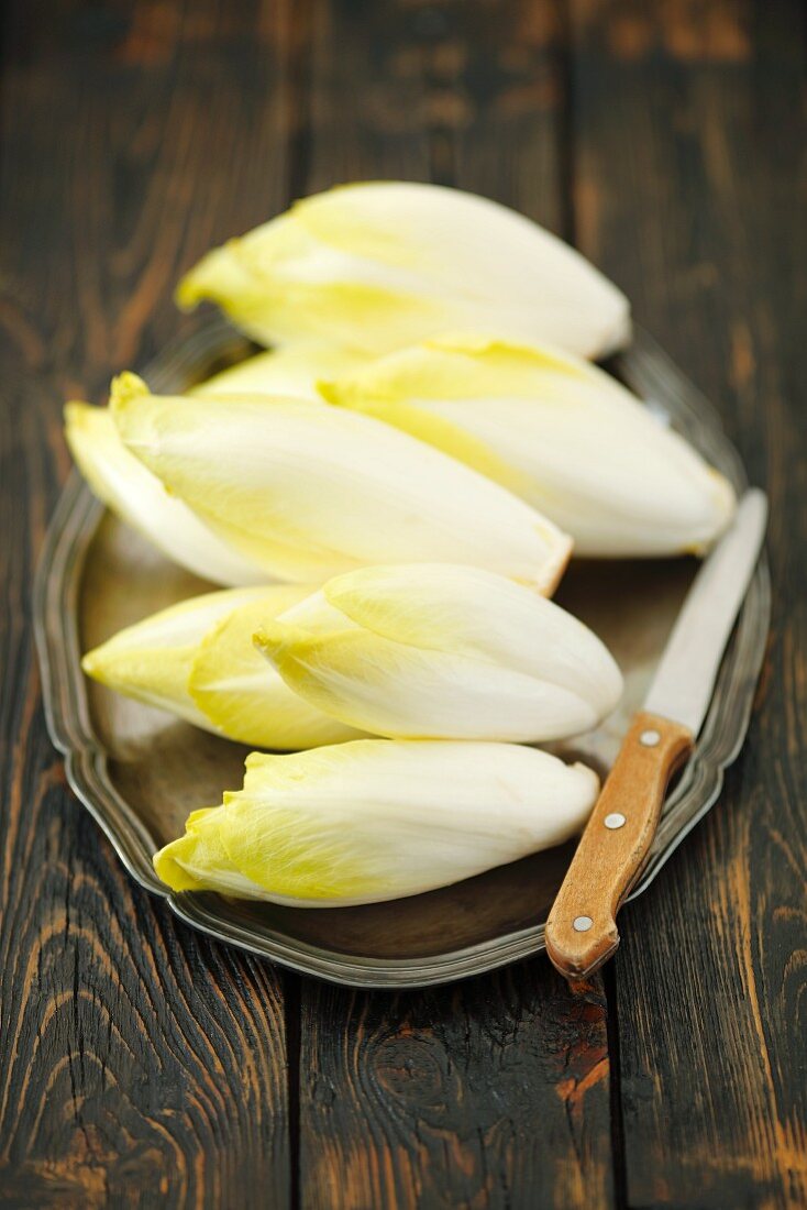Chicory on a tray with a knife